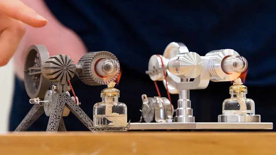 Redesigned, 3D-printed Sterling engine model on the left and original Sterling engine model on the right